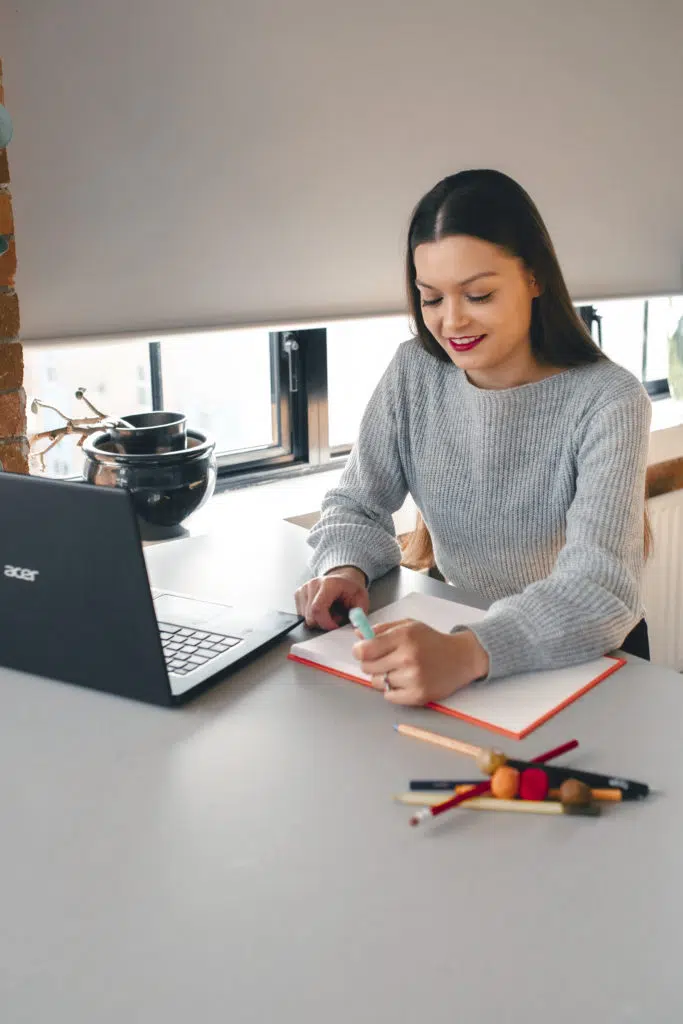 Student writing notes in notebook