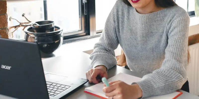 Student writing notes in notebook
