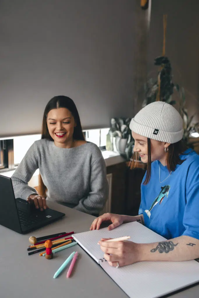 Students laughing looking at laptop