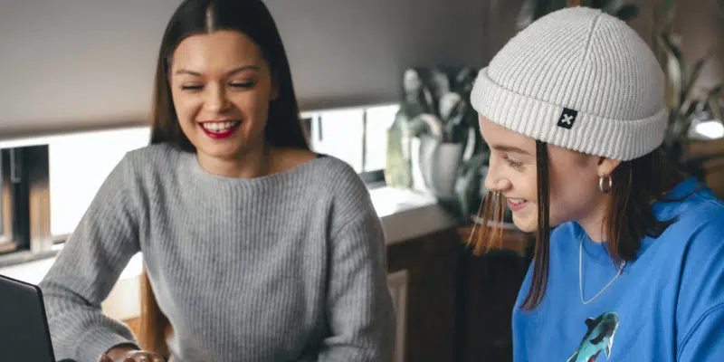 Students laughing looking at laptop