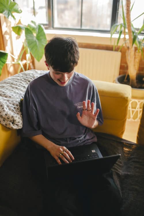 Corey waving at laptop