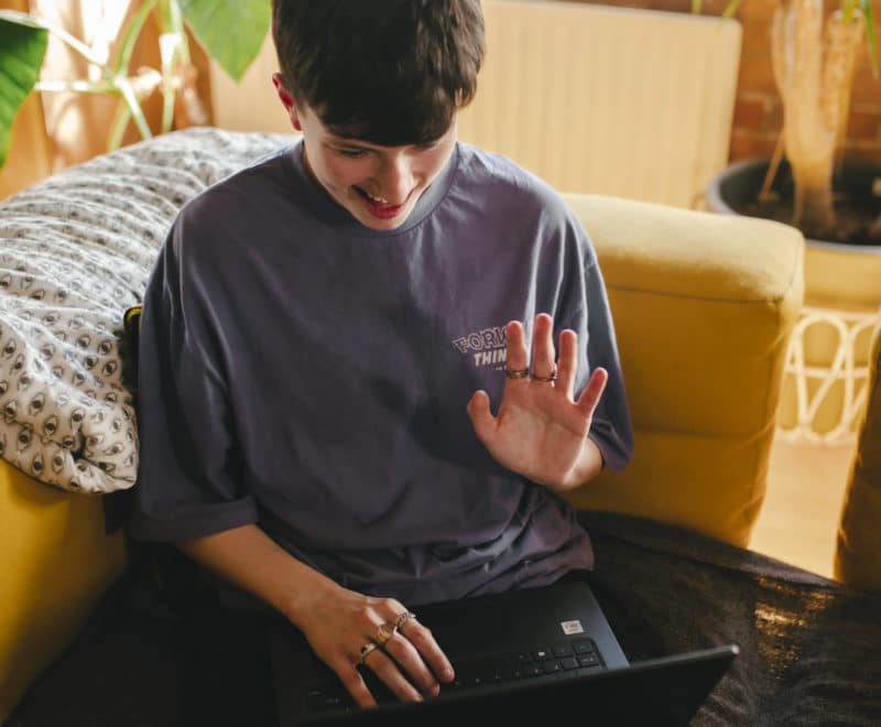 Corey waving at laptop