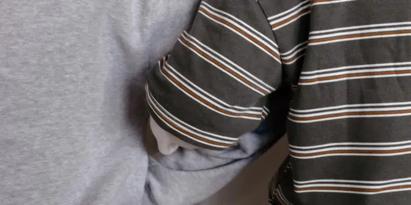 Two people arm in arm