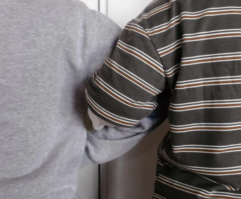 Two people arm in arm