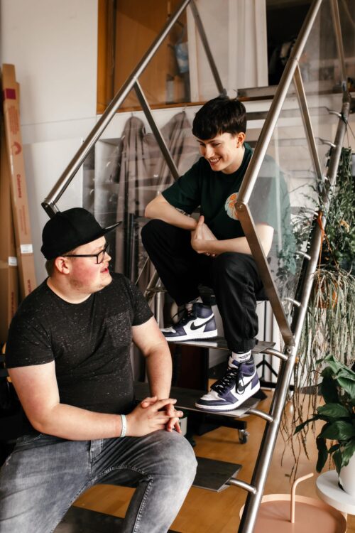 Austin and Corey talking sat on stairs