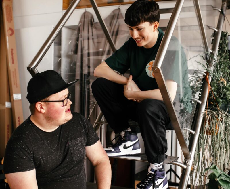 Austin and Corey talking sat on stairs