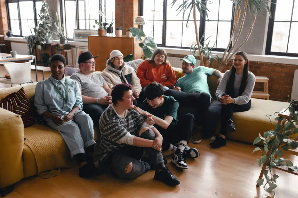 Big group of young people laughing altogether