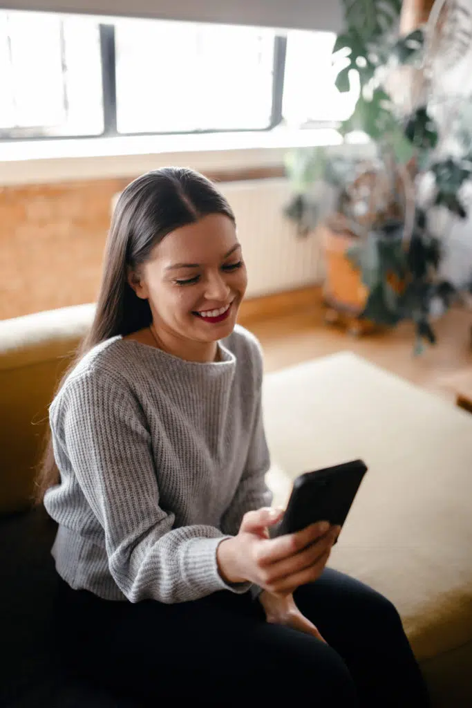 Jasmine smiling at her phone