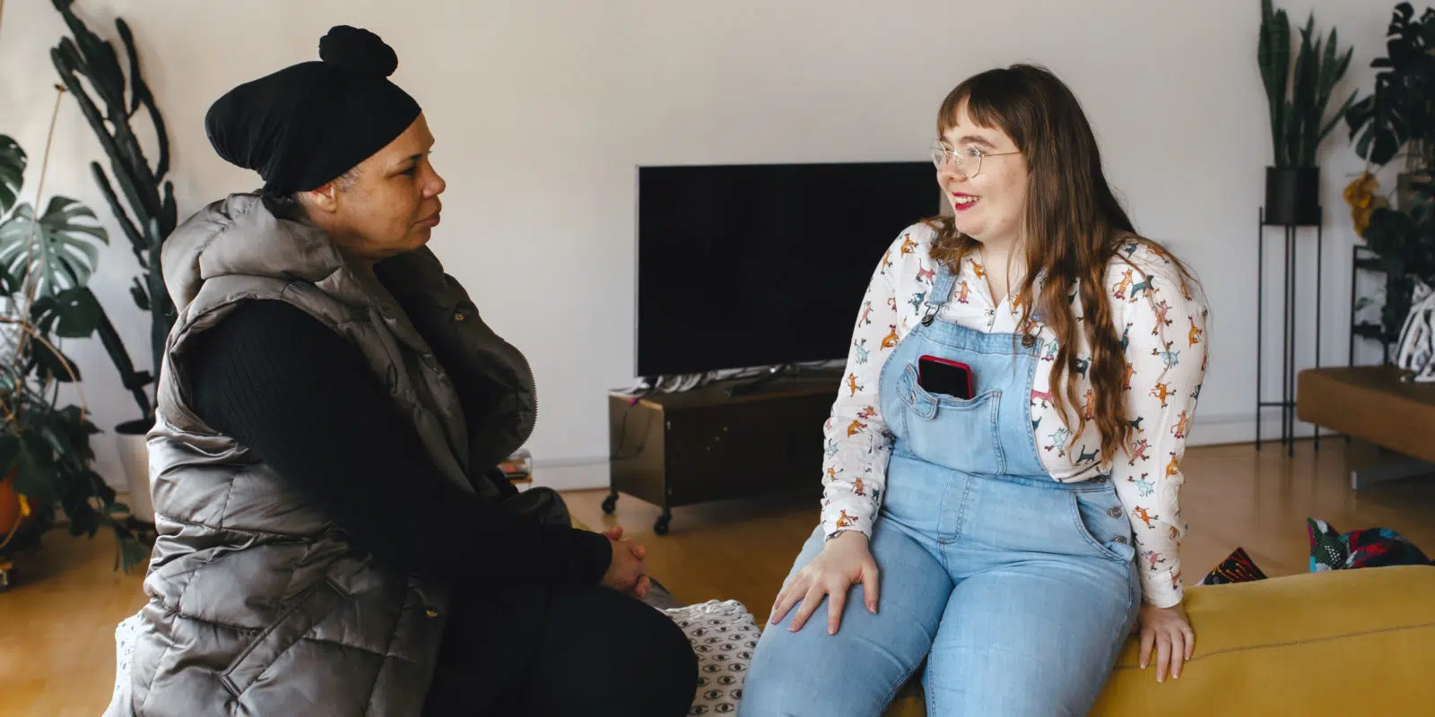 Professional and young person having conversation, young person smiling