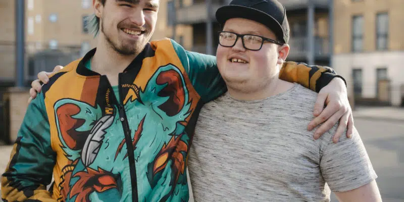 Ozzy and Aaron arms around each other stood outside