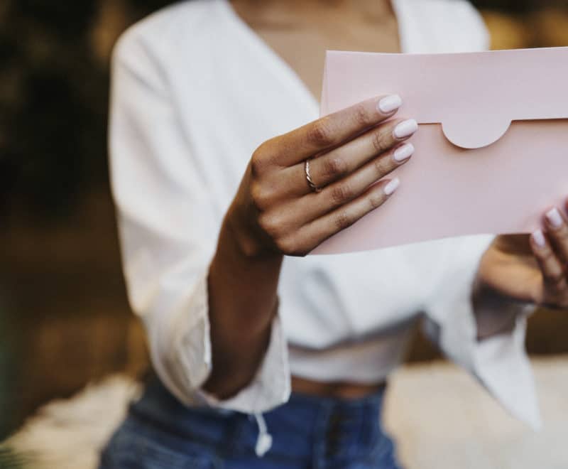 Woman's hands holding an envelope.