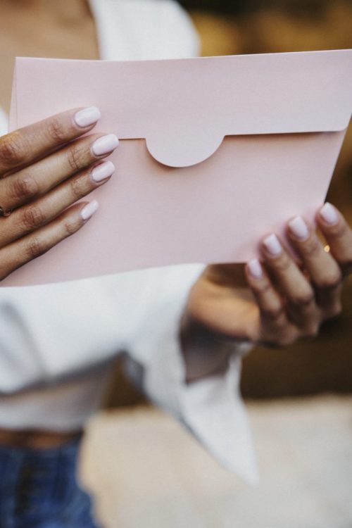 Woman's hands holding an envelope.