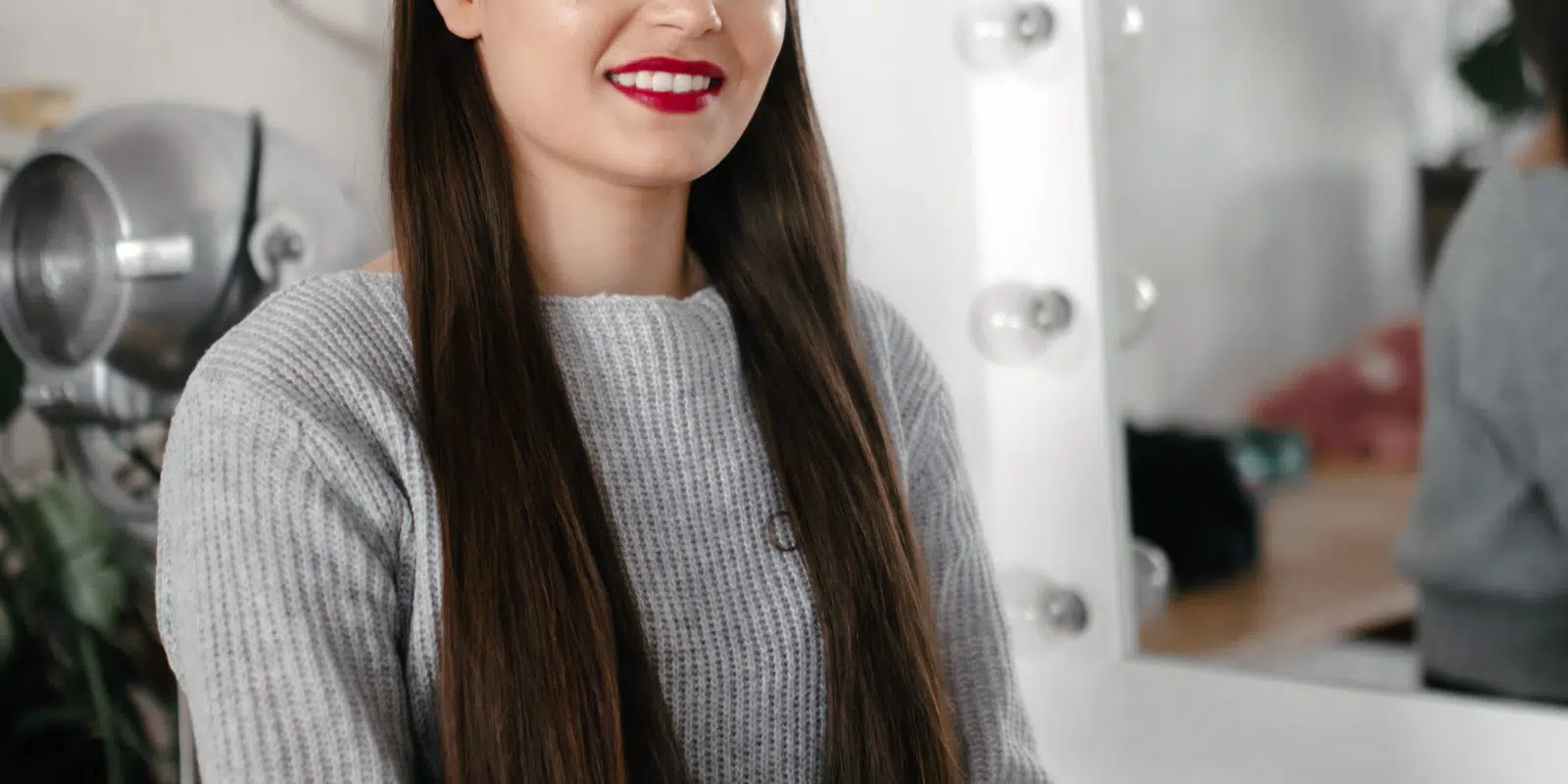 Jasmine smiling sat on a chair