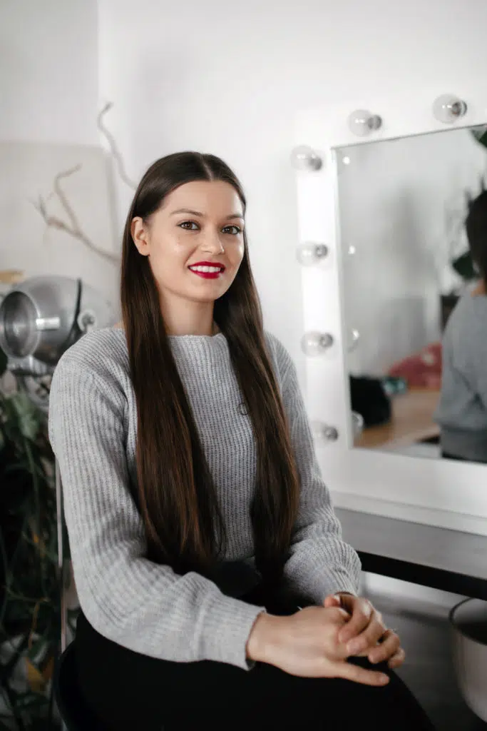 Jasmine smiling sat on a chair