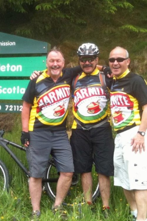 Andy, Eduardo and friend stand at the border between England and Scotland