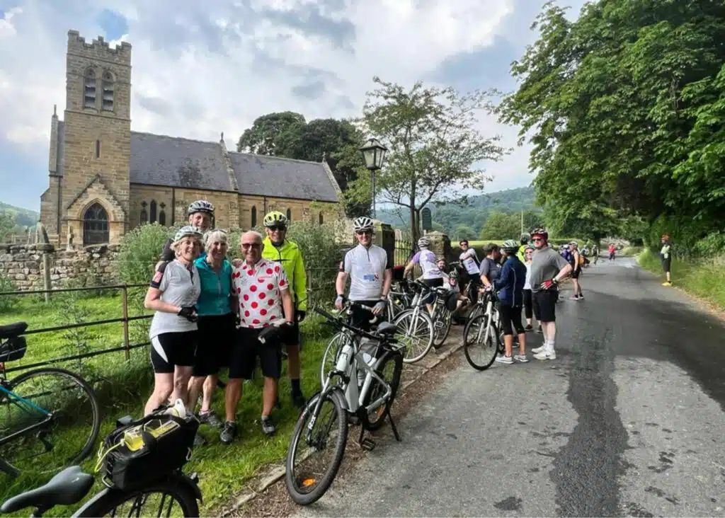 Group of cyclists standing in front of a church