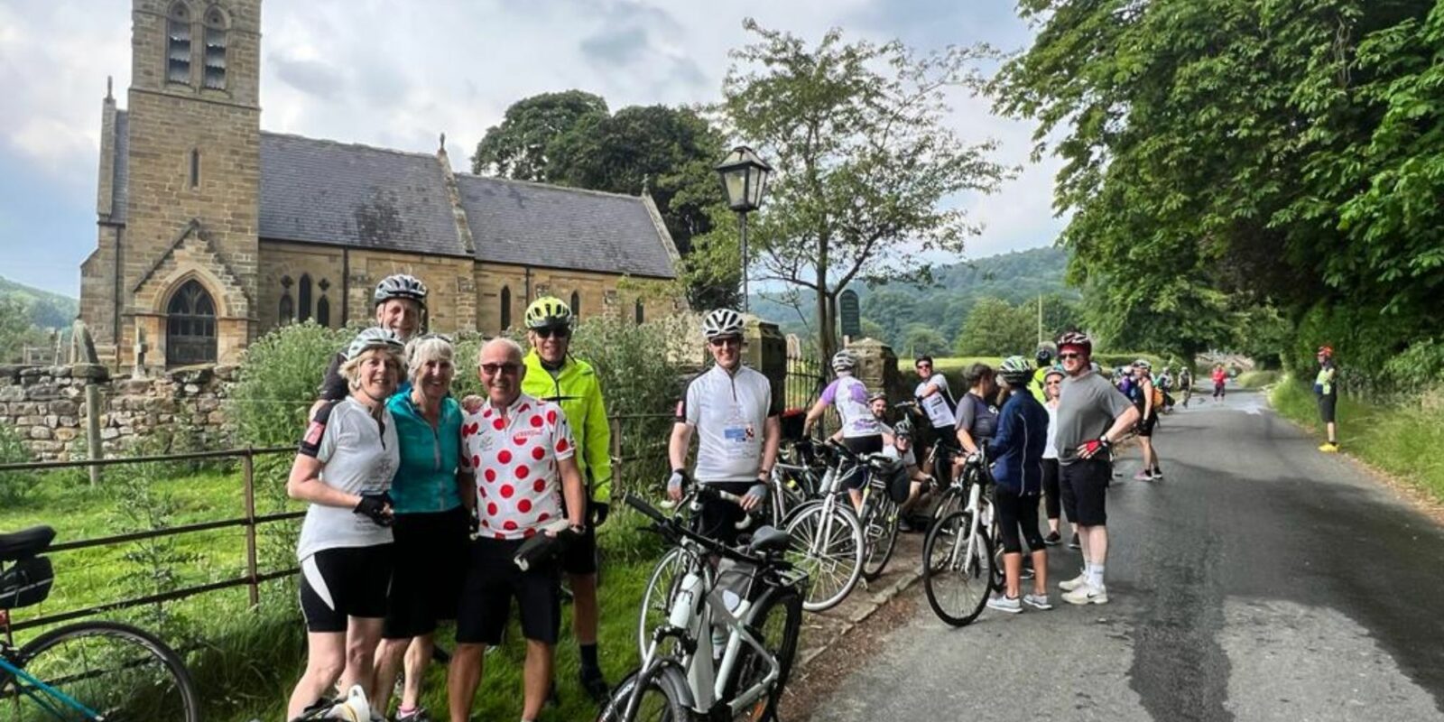 Group of cyclists standing in front of a church