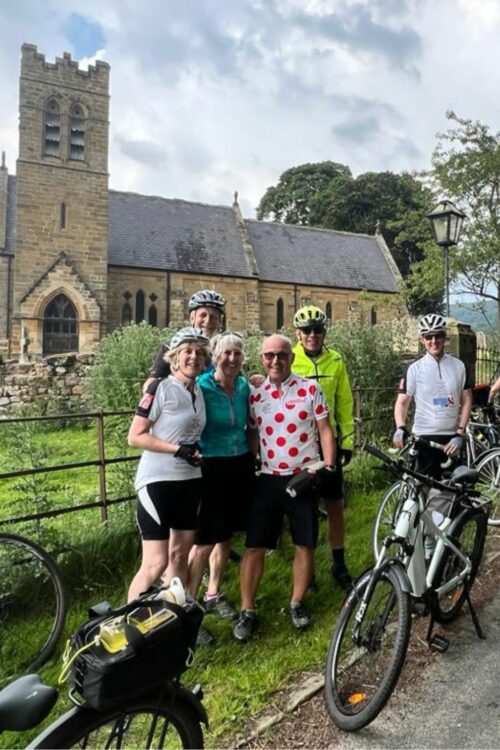 Group of cyclists standing in front of a church