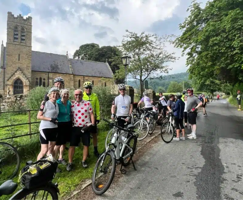 Group of cyclists standing in front of a church