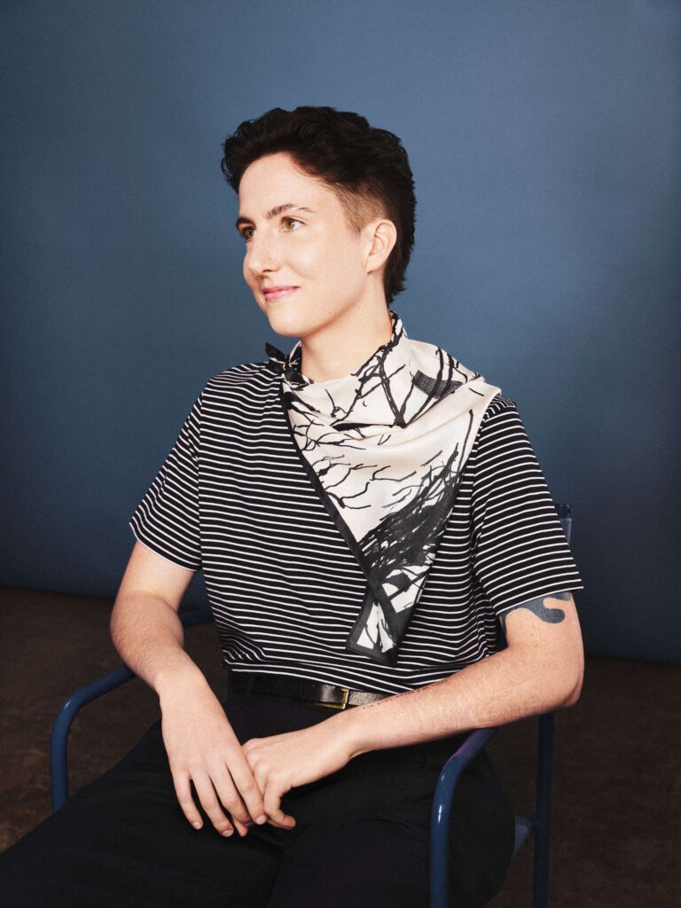Izaac wearing a scarf from the Made by Care gifting range